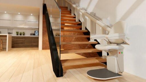 Stair lift installed on wooden staircase to support safe aging-in-place mobility